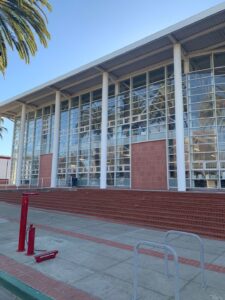 A massive glass facade on a public or institutional building with red brick steps, cleaned by Spotfree Window's business window cleaning service.