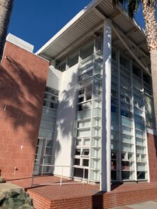 A modern building with tall white pillars and complex window sections, cleaned by Spotfree Window for a pristine business exterior.