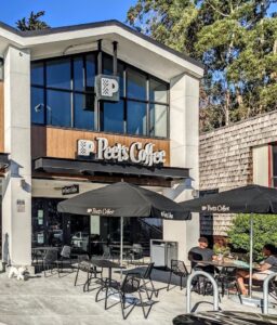 A clean Peet's Coffee storefront with large upper and lower windows reflecting sunlight after professional business window cleaning by Spotfree Window.