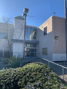 The exterior entrance of a police department with clean glass doors and windows, professionally washed by Spotfree Window.