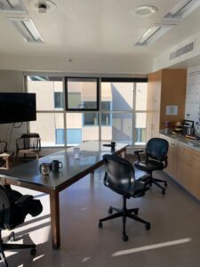 A clean, sunlit conference room with polished table and large windows, sparkling after business window cleaning by Spotfree Window.